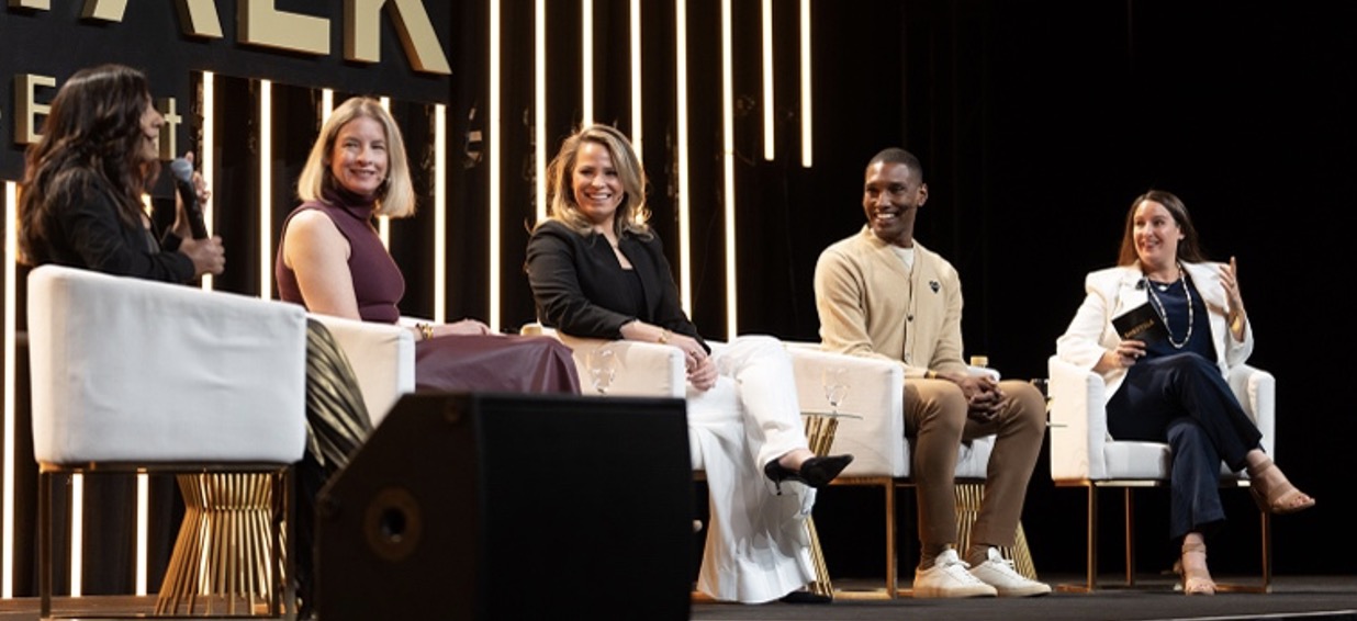 A group of people sitting on a stage AI-generated content may be incorrect.